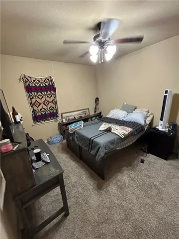 a bed room with a bed window and a chandelier
