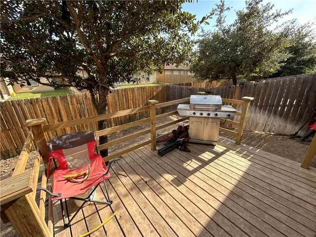 a view of a deck with wooden floor and outdoor seating