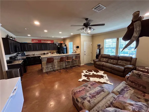 a living room with furniture and kitchen view