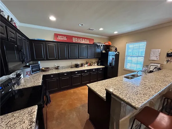 a kitchen with granite countertop lots of counter top space and appliances