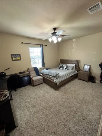 a living room with furniture and a ceiling fan