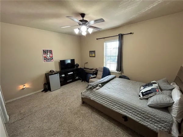 a bedroom with furniture and a chandelier