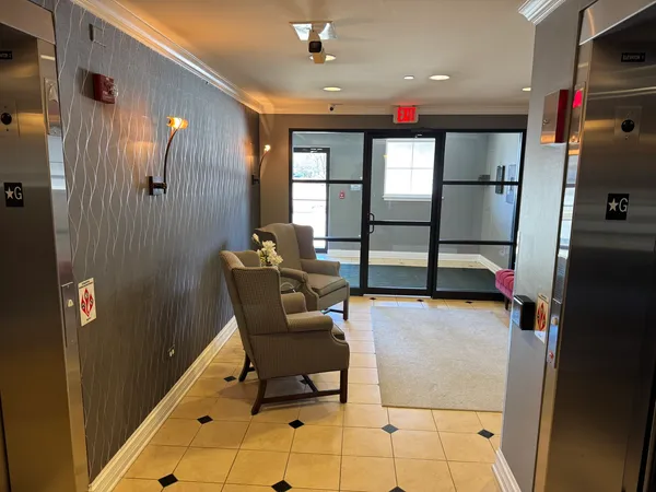 a view of a hallway with furniture and window