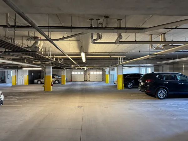 a view of parking garage with cars