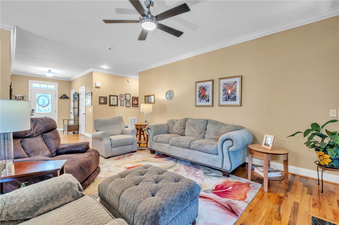 648 Mountain View Road Williamston, SC 29697 - Photo 6 of 42 An inviting living room features gleaming hardwood floors and a modern ceiling fan.