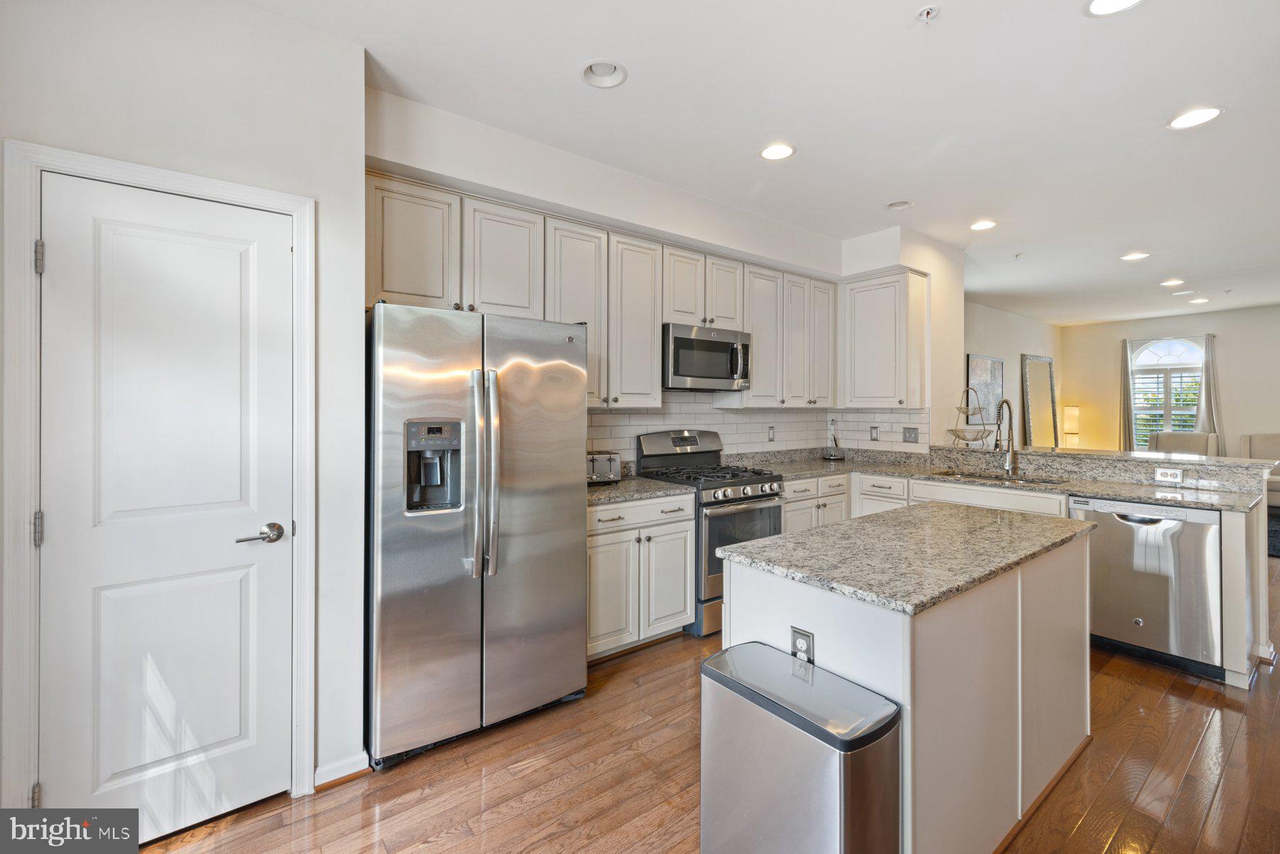 2514 Ralph Ellison Way Northeast Washington, DC 20018 - Photo 12 of 31 a kitchen with stainless steel appliances granite countertop a refrigerator a sink a stove a microwave and island