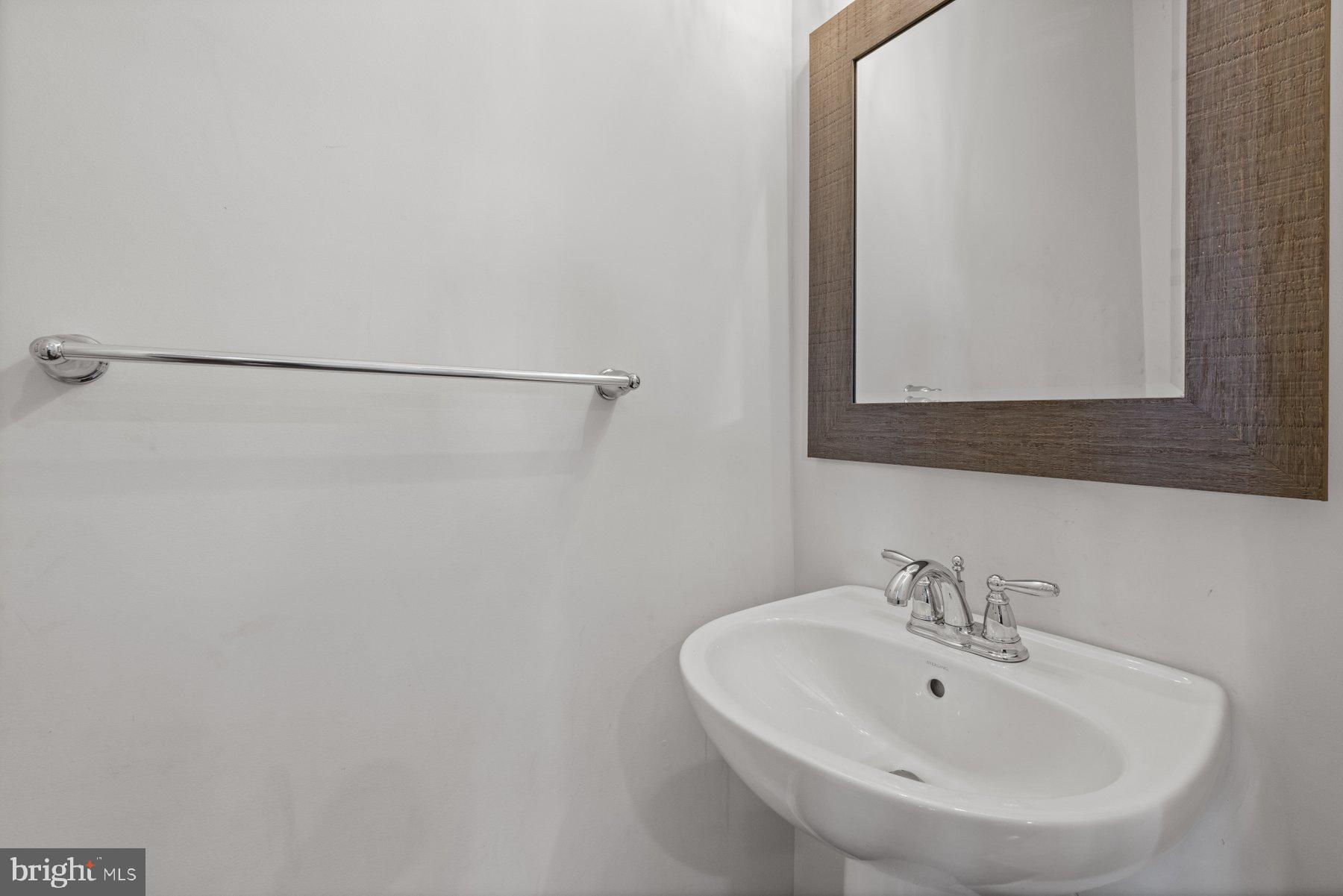 2514 Ralph Ellison Way Northeast Washington, DC 20018 - Photo 18 of 31 a bathroom with a sink and a mirror
