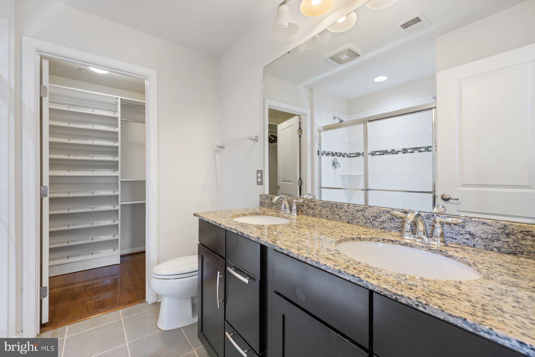 2514 Ralph Ellison Way Northeast Washington, DC 20018 - Photo 27 of 31 a bathroom with a granite countertop sink a toilet and a large mirror