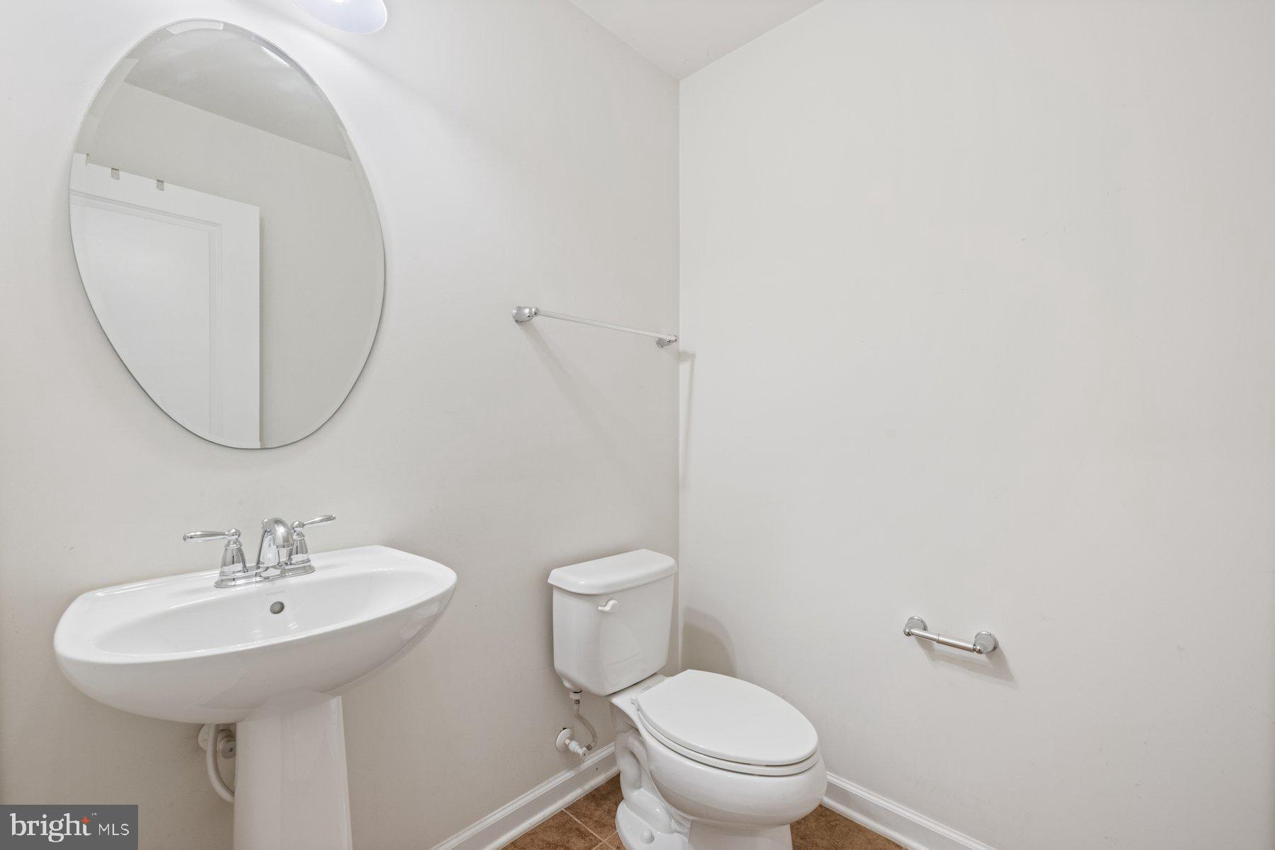 2514 Ralph Ellison Way Northeast Washington, DC 20018 - Photo 7 of 31 a bathroom with a toilet a sink and a mirror