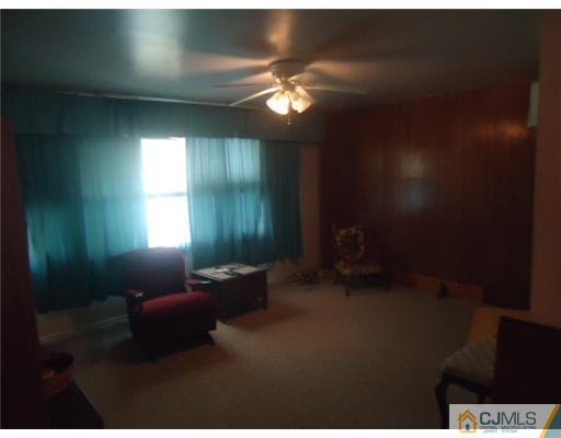 56 Princeton Road Old Bridge, NJ 08859 - Photo 4 of 8 a living room with furniture and a chandelier