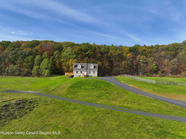a living room with furniture a rug and a chandelier
