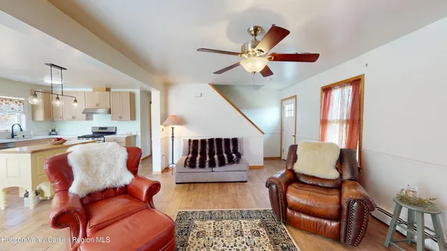 a view of empty room with window and wooden floor