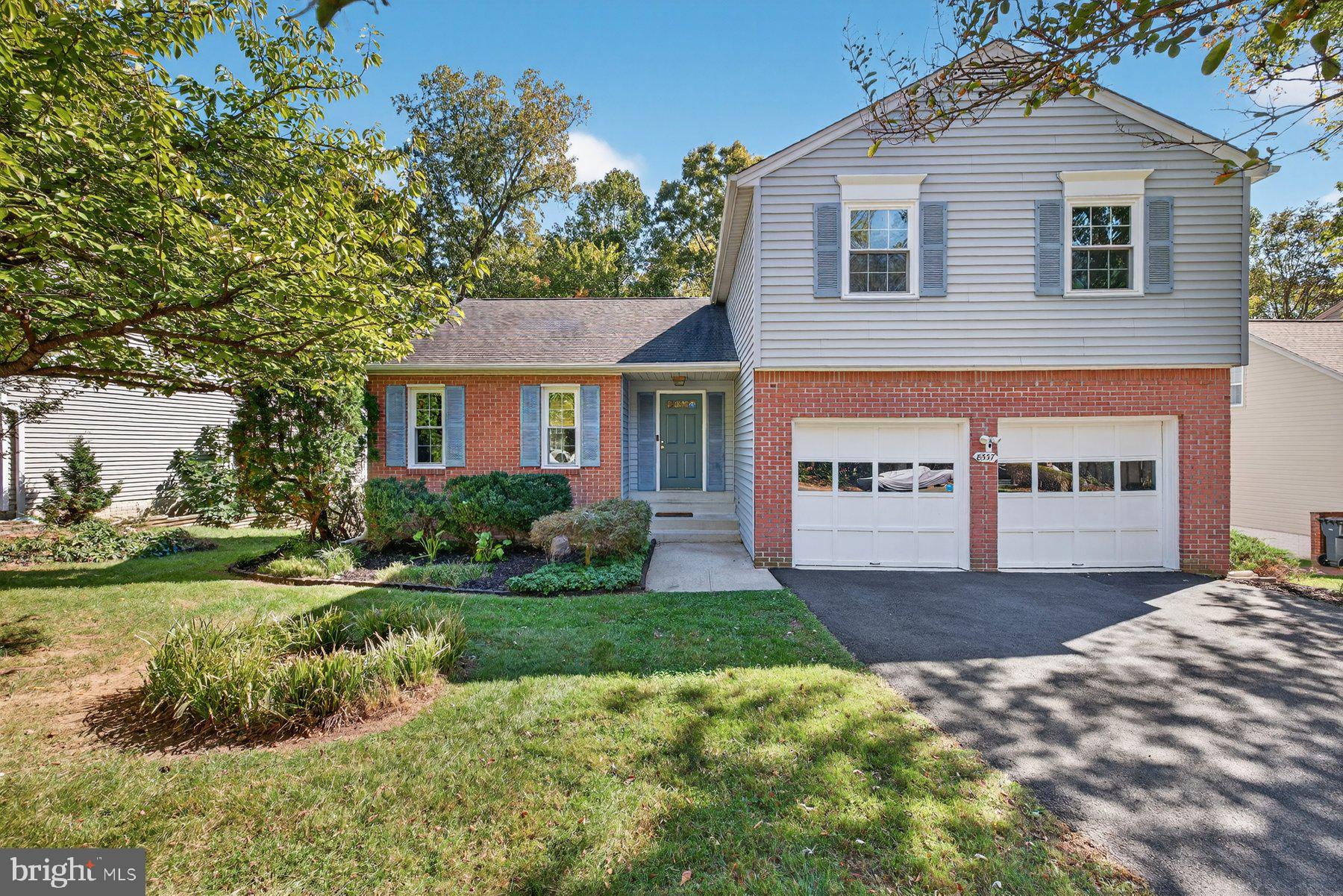 8537 Hooes Road Springfield, VA 22153 - Photo 1 of 30 a front view of a house with a yard and garage
