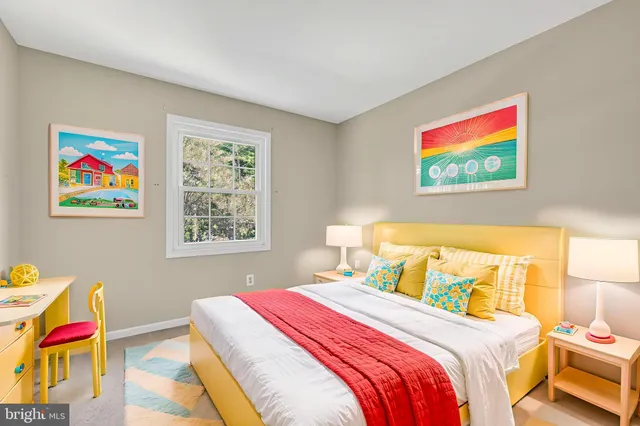 a bedroom with a bed and painting on the wall