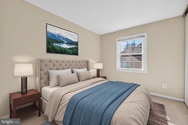 a bedroom with bed and a night stand