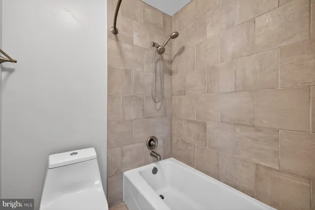 a bathroom with a bathtub and a toilet