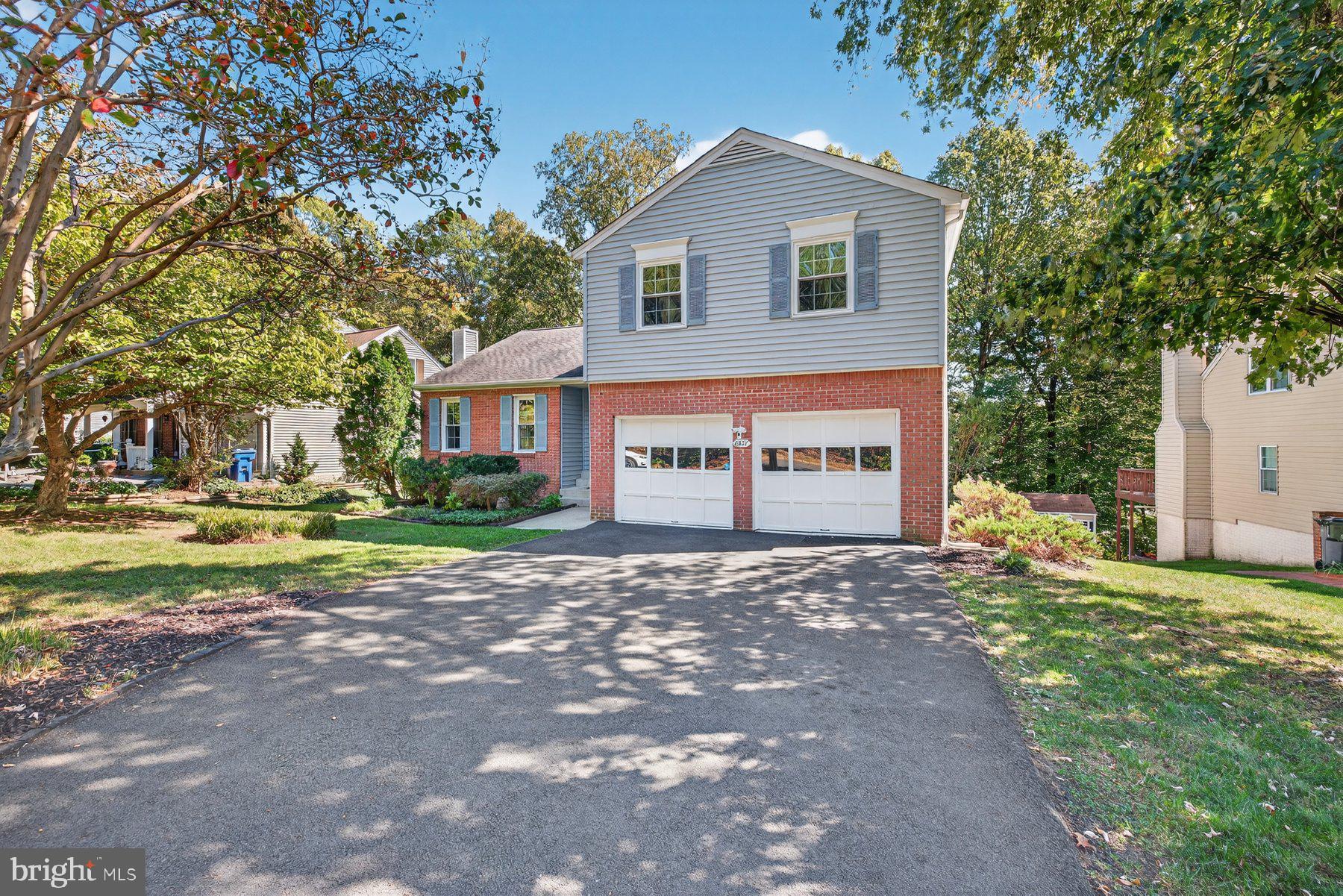 8537 Hooes Road Springfield, VA 22153 - Photo 2 of 30 a view of a house with a yard and large tree