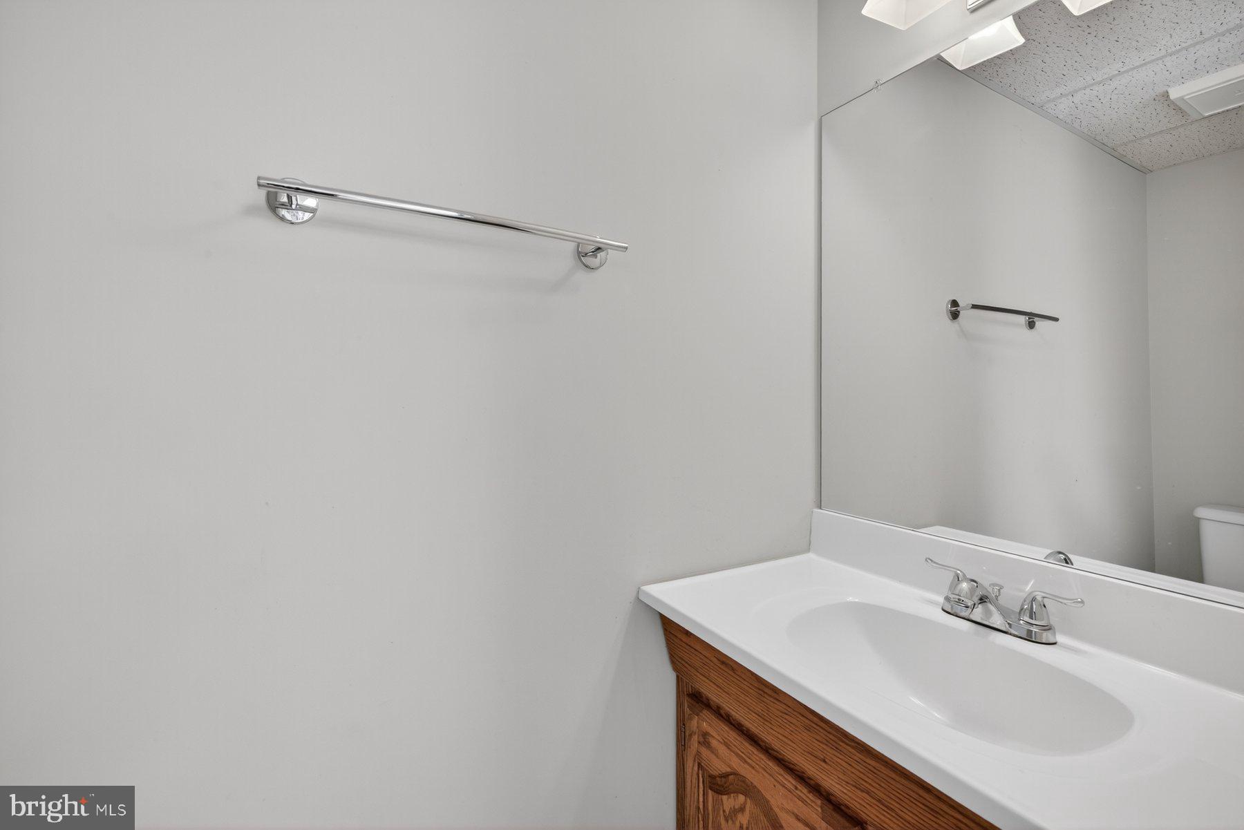 8537 Hooes Road Springfield, VA 22153 - Photo 26 of 30 a bathroom with a sink and a mirror