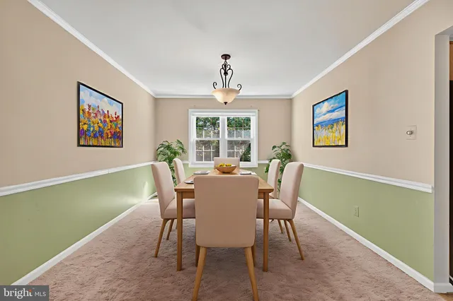 a dining room with furniture a window and a rug