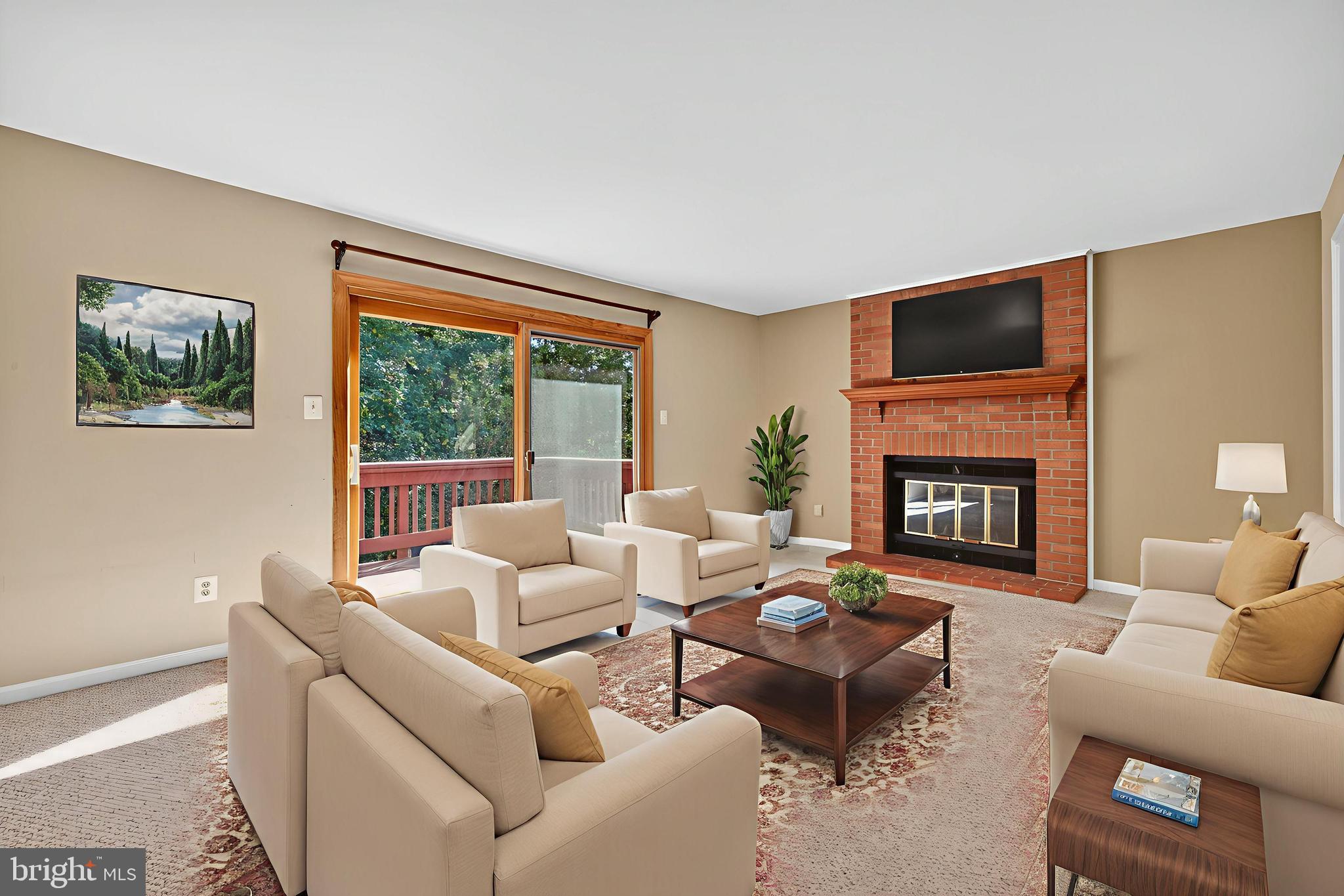8537 Hooes Road Springfield, VA 22153 - Photo 6 of 30 a living room with furniture a fireplace and a flat screen tv