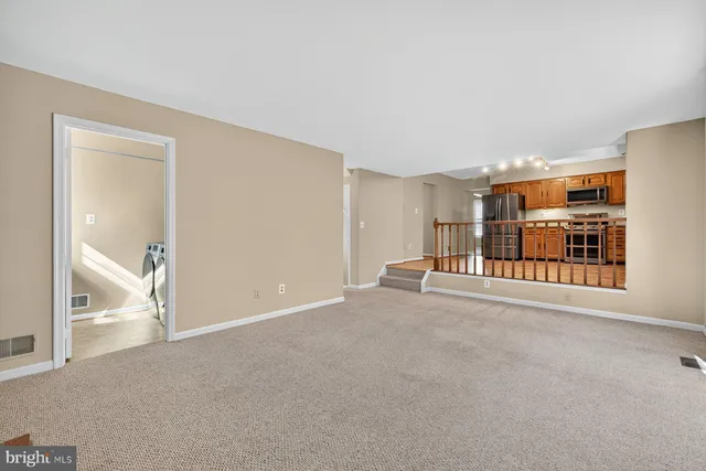 a view of a livingroom with furniture and an entryway