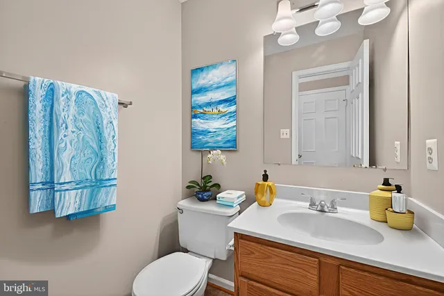 a bathroom with a sink mirror vanity and toilet