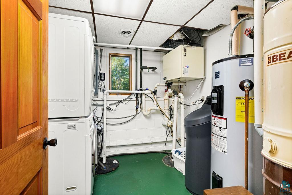 5370 Ugstad Road Hermantown, MN 55811 - Photo 21 of 68 Laundry area featuring a stacked washer and dryer, a water heater, a water softener, and a window