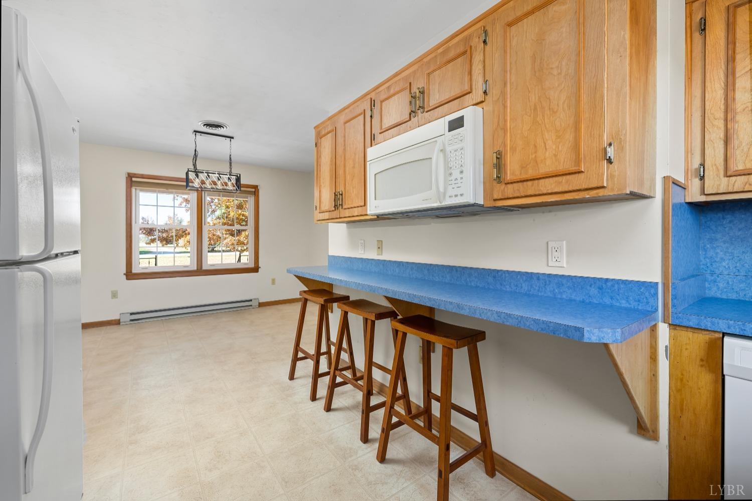 10572 Red House Road Red House, VA 23963 - Photo 11 of 21 a kitchen with stainless steel appliances granite countertop a stove a sink and a microwave