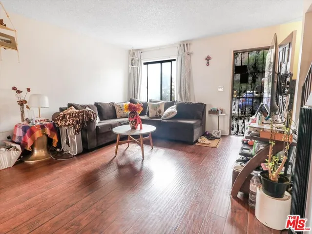 a living room with furniture a couch and a floor to ceiling window