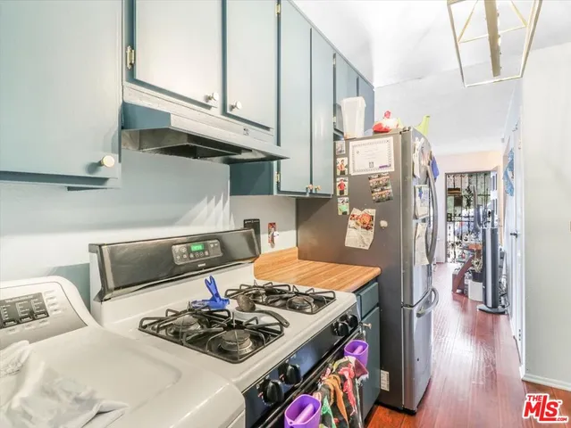 a kitchen with stainless steel appliances granite countertop a stove and a refrigerator