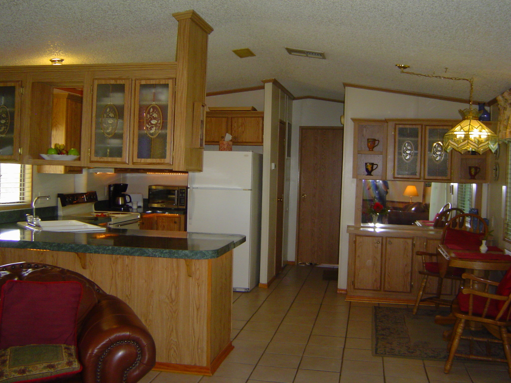 108 North Tomahawk Road Apache Junction, AZ 85119 - Photo 3 of 9 a kitchen with refrigerator and cabinets