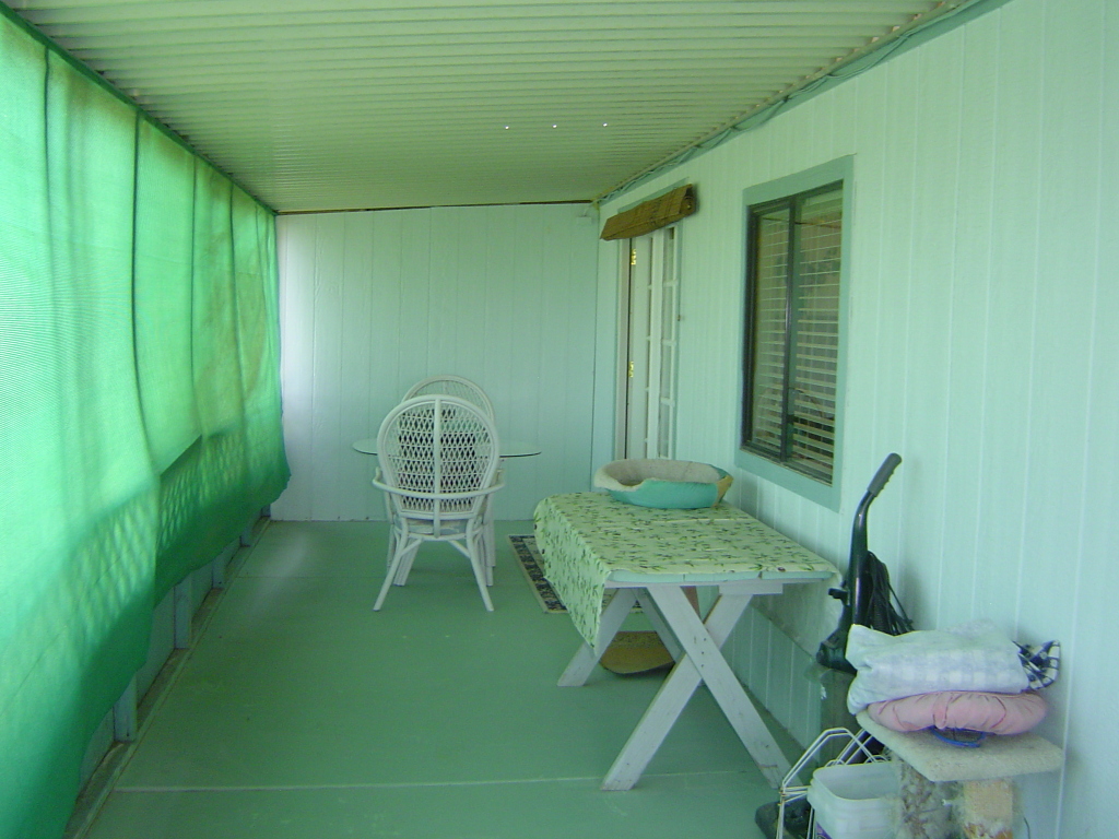 108 North Tomahawk Road Apache Junction, AZ 85119 - Photo 4 of 9 a view of a backyard with table and chairs