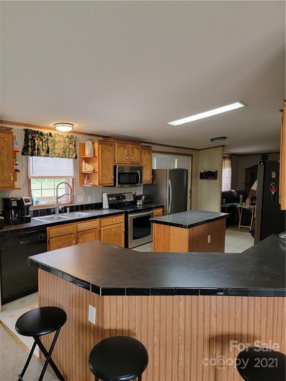3014 Anderson Road South Catawba, SC 29704 - Photo 12 of 21 a kitchen with stainless steel appliances granite countertop a sink a stove top oven a counter space and cabinets