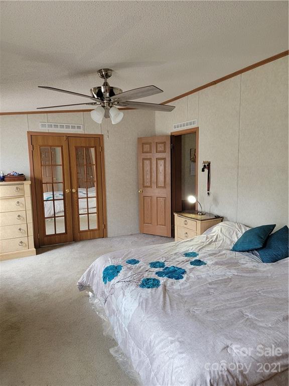 3014 Anderson Road South Catawba, SC 29704 - Photo 13 of 21 a bedroom with a bed dresser and chandelier