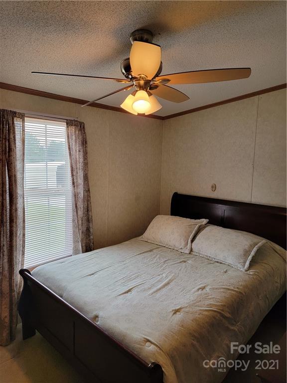 3014 Anderson Road South Catawba, SC 29704 - Photo 17 of 21 a bedroom with a bed and a chandelier