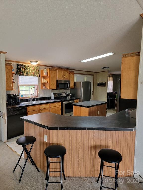 3014 Anderson Road South Catawba, SC 29704 - Photo 7 of 21 a kitchen with stainless steel appliances granite countertop a stove top oven a sink a dining table and chairs