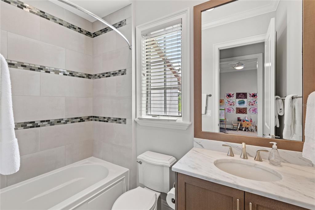 10224 Mattraw Place Orlando, FL 32836 - Photo 28 of 43 a bathroom with a granite countertop sink toilet and shower