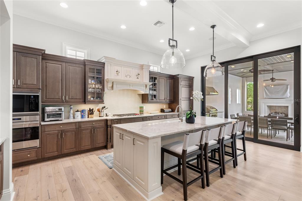 10224 Mattraw Place Orlando, FL 32836 - Photo 5 of 43 a kitchen with stainless steel appliances granite countertop a stove top oven a refrigerator a sink and chairs