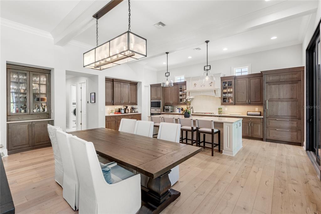 10224 Mattraw Place Orlando, FL 32836 - Photo 9 of 43 a kitchen with kitchen island a sink table and chairs