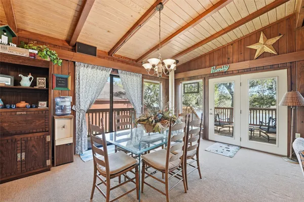 a dining room with furniture water view and balcony