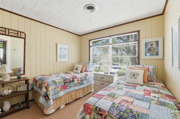 a bedroom that has two beds and a table in it