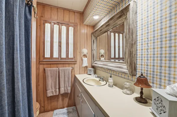 a bathroom with a sink a toilet and a window