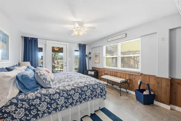 a bedroom with a large bed and a window