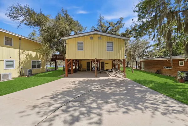 a view of a house with backyard and a sitting area