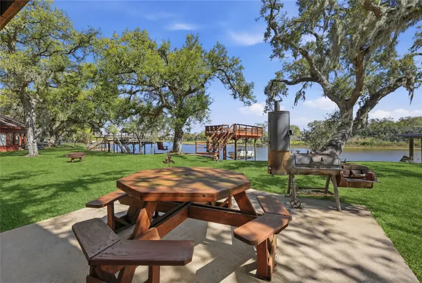 a view of a backyard with sitting area furniture and a fire pit