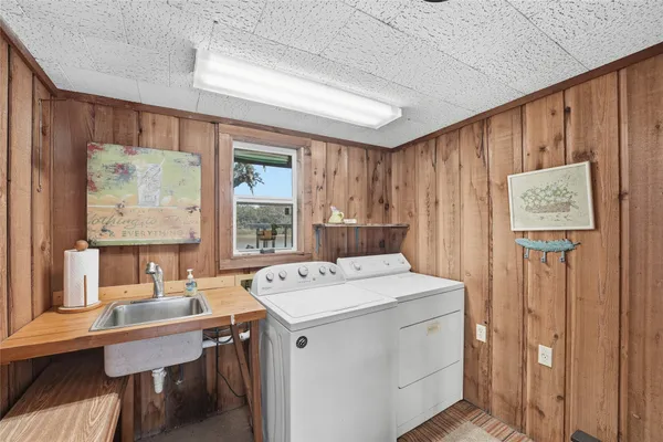 a utility room with dryer washer and a window