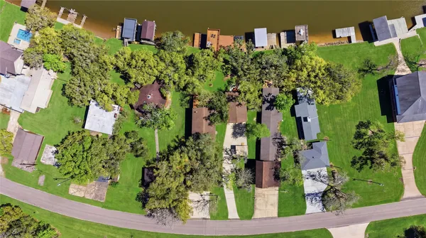 an aerial view of multiple houses with yard