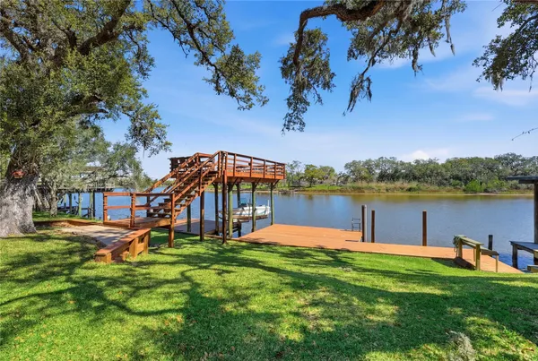 a view of a house with a yard and a fountain