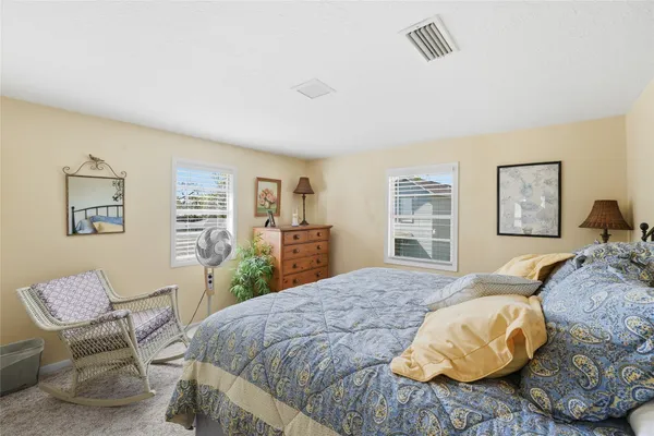 a bedroom with a bed and a chair