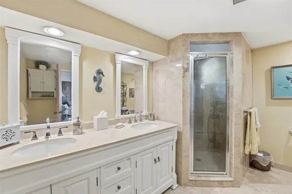 a bathroom with double sink and a mirror
